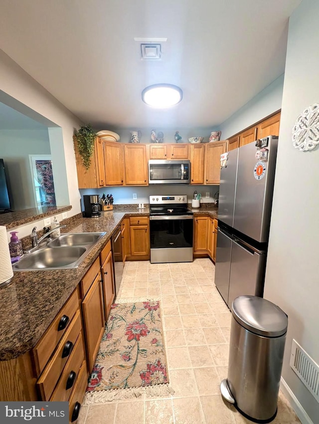 513 Dakemich Ct, Enola, PA 17025 - kitchen with appliances with stainless steel finishes, a sink, and brown cabinets