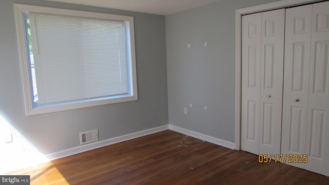5901 Taylor Rd, Riverdale, MD 20737 - unfurnished bedroom with dark wood-style flooring, a closet, and baseboards