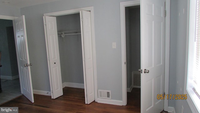 5901 Taylor Rd, Riverdale, MD 20737 - unfurnished bedroom featuring dark wood-style flooring, baseboards, and a closet