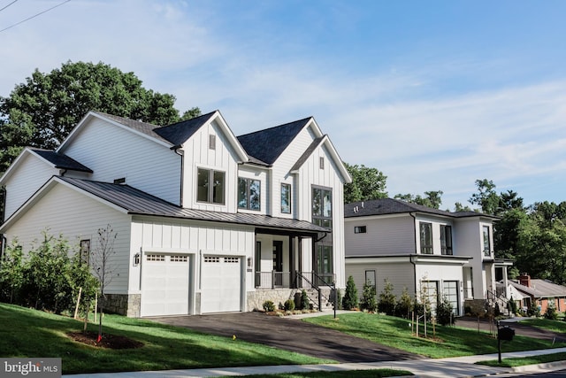 10021 Glenmere Rd, Fairfax, VA 22032 - modern inspired farmhouse with a standing seam roof, driveway, a front lawn, board and batten siding, and a garage