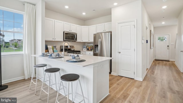 57 Alexander Way, Westampton, NJ 08060 - kitchen featuring stainless steel appliances, a peninsula, a breakfast bar, light countertops, and white cabinets