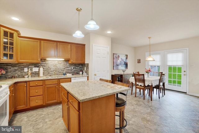4 Hardy Ct, Lancaster, PA 17602 - kitchen featuring tasteful backsplash, a sink, glass insert cabinets, a kitchen bar, and light stone counters