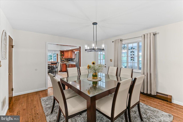 320 Lees Brg, Nottingham, PA 19362 - dining area with light wood-style flooring, a chandelier, baseboards, and a baseboard heating unit