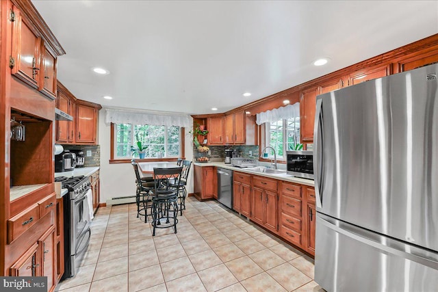 320 Lees Brg, Nottingham, PA 19362 - kitchen featuring stainless steel appliances, a sink, light countertops, backsplash, and brown cabinetry
