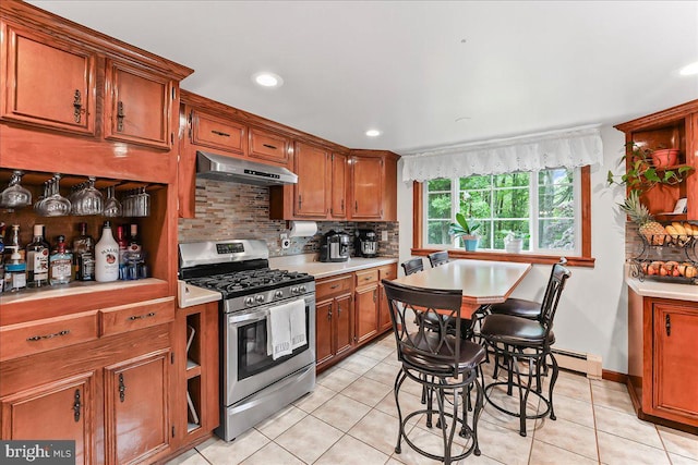 320 Lees Brg, Nottingham, PA 19362 - kitchen with stainless steel gas stove, under cabinet range hood, a baseboard radiator, tasteful backsplash, and light countertops