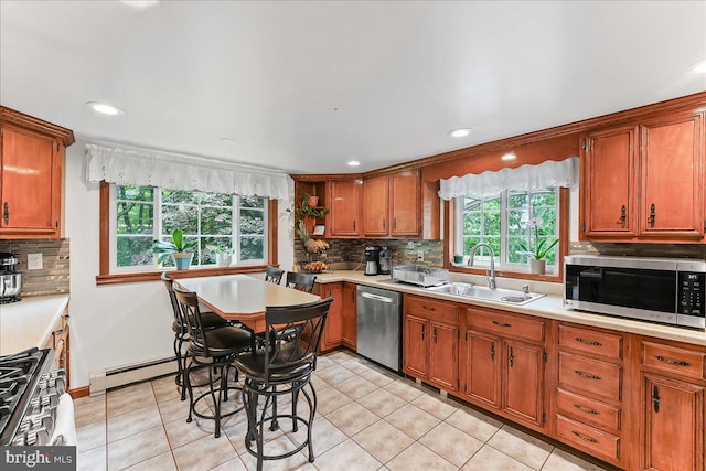 320 Lees Brg, Nottingham, PA 19362 - kitchen featuring appliances with stainless steel finishes, baseboard heating, light countertops, backsplash, and a sink