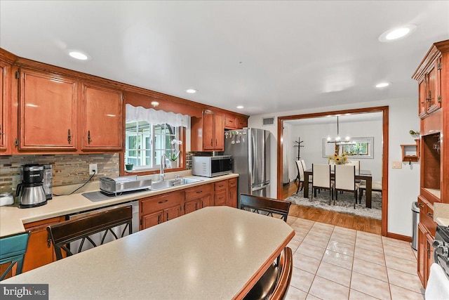 320 Lees Brg, Nottingham, PA 19362 - kitchen with freestanding refrigerator, light countertops, backsplash, light tile patterned floors, and recessed lighting