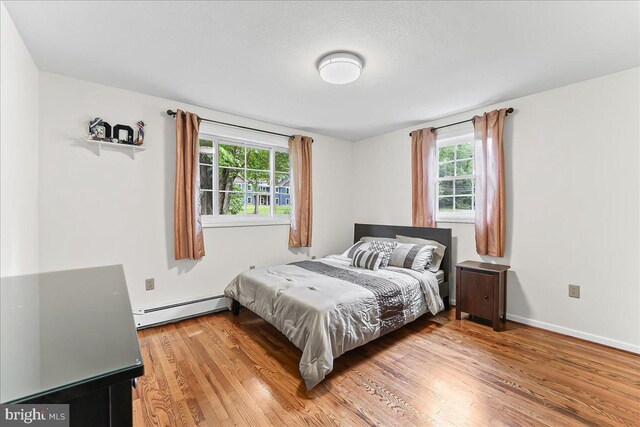 320 Lees Brg, Nottingham, PA 19362 - bedroom with a baseboard heating unit, light wood finished floors, and baseboards