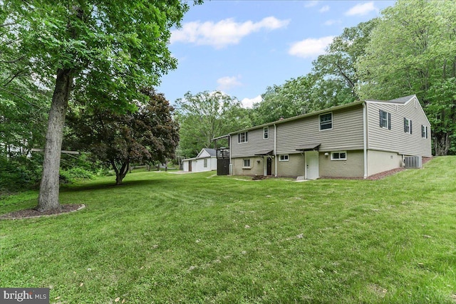 320 Lees Brg, Nottingham, PA 19362 - rear view of house with central air condition unit, a yard, and a garage