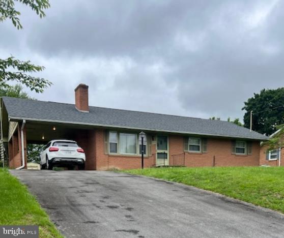 421 Superior Ave, Winchester, VA 22601 - ranch-style home with driveway, a chimney, a front yard, brick siding, and a carport