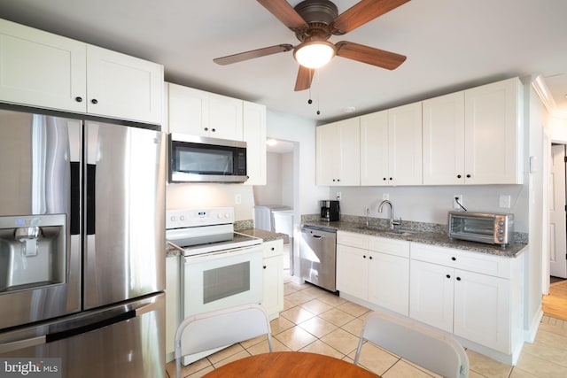 143 Baker St, Manassas Park, VA 20111 - kitchen featuring appliances with stainless steel finishes, a sink, white cabinetry, ceiling fan, and dark stone countertops