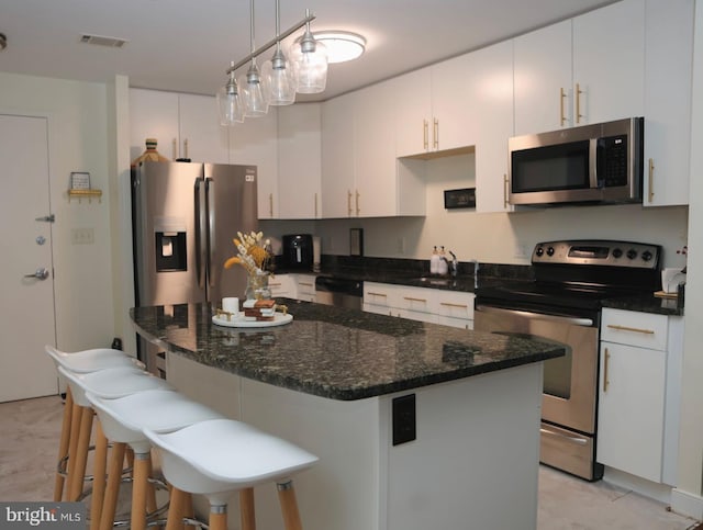 157 Fleet Unit 307, Oxon Hill, MD 20745 - kitchen featuring appliances with stainless steel finishes, white cabinets, and a kitchen bar