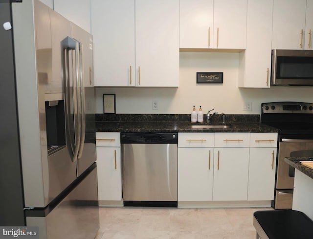 157 Fleet Unit 307, Oxon Hill, MD 20745 - kitchen with stainless steel appliances, a sink, white cabinets, and dark stone counters