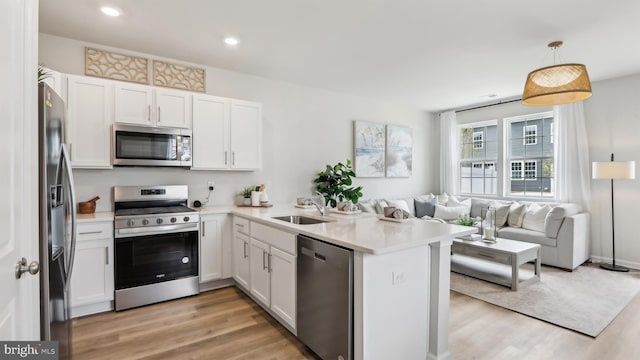 210 Bentz Ave, Villas, NJ 08251 - kitchen with stainless steel appliances, open floor plan, a peninsula, light wood-type flooring, and recessed lighting