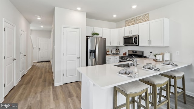 210 Bentz Ave, Villas, NJ 08251 - kitchen with stainless steel appliances, a peninsula, wood finished floors, a kitchen breakfast bar, and recessed lighting