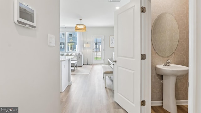 210 Bentz Ave, Villas, NJ 08251 - hallway with light wood-style flooring, baseboards, and a sink
