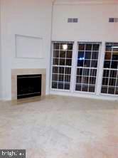 6212 Westchester Park Dr Unit J, College Park, MD 20740 - unfurnished living room with a fireplace