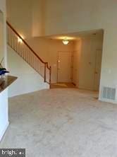 6212 Westchester Park Dr Unit J, College Park, MD 20740 - unfurnished living room featuring stairs