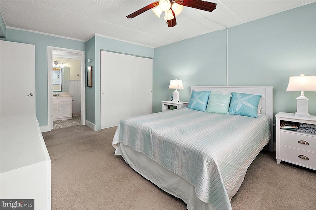 13 60th St Unit 201, Ocean City, MD 21842 - carpeted bedroom with a closet, ornamental molding, ensuite bath, a ceiling fan, and baseboards