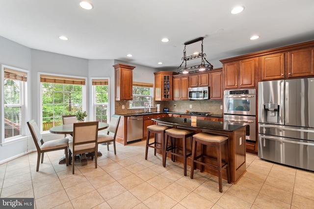 42026 Zircon Dr, Aldie, VA 20105 - kitchen with appliances with stainless steel finishes, a sink, backsplash, brown cabinetry, and recessed lighting