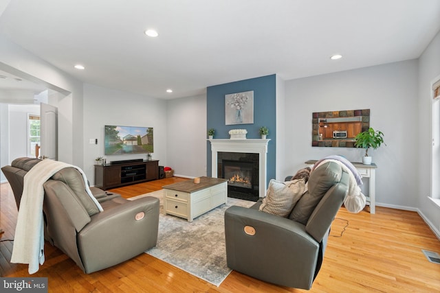 42026 Zircon Dr, Aldie, VA 20105 - living room with light wood-style floors, recessed lighting, a fireplace with flush hearth, and baseboards