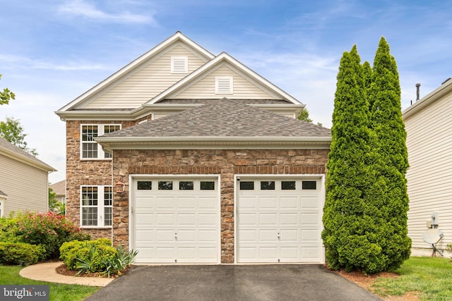 42026 Zircon Dr, Aldie, VA 20105 - view of front facade featuring stone siding, driveway, a garage, and roof with shingles