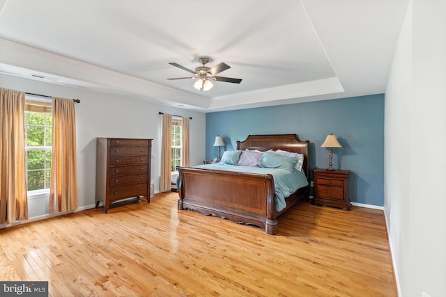 42026 Zircon Dr, Aldie, VA 20105 - bedroom with a raised ceiling, light wood-type flooring, baseboards, and a ceiling fan