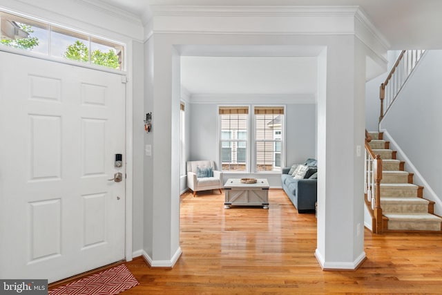42026 Zircon Dr, Aldie, VA 20105 - foyer featuring baseboards, light wood-type flooring, healthy amount of natural light, stairs, and ornamental molding