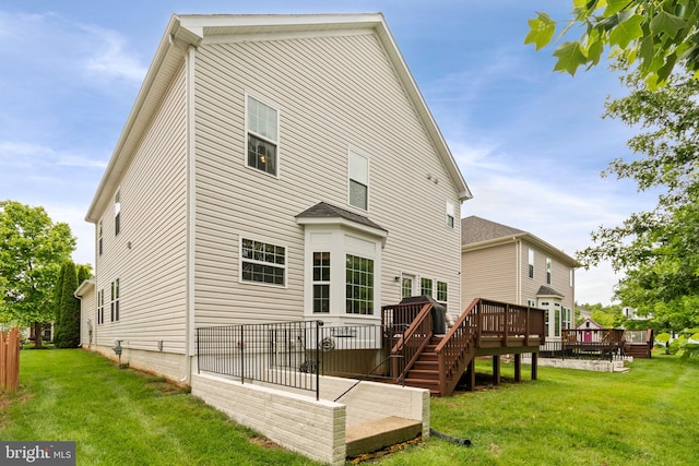 42026 Zircon Dr, Aldie, VA 20105 - rear view of property featuring a lawn and a wooden deck