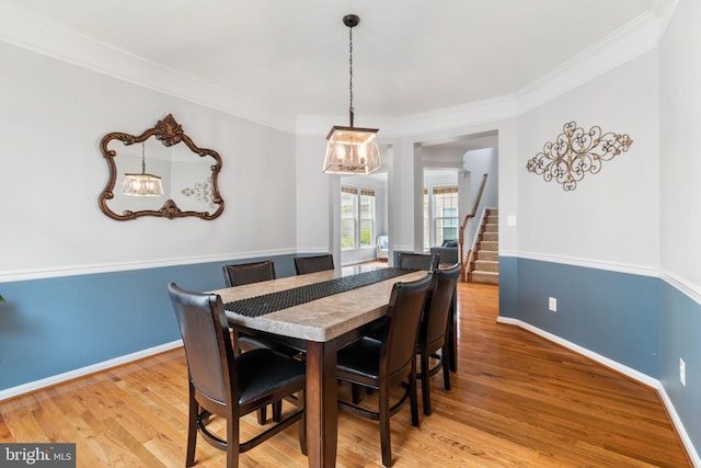 42026 Zircon Dr, Aldie, VA 20105 - dining room featuring a chandelier, wood finished floors, stairway, crown molding, and baseboards