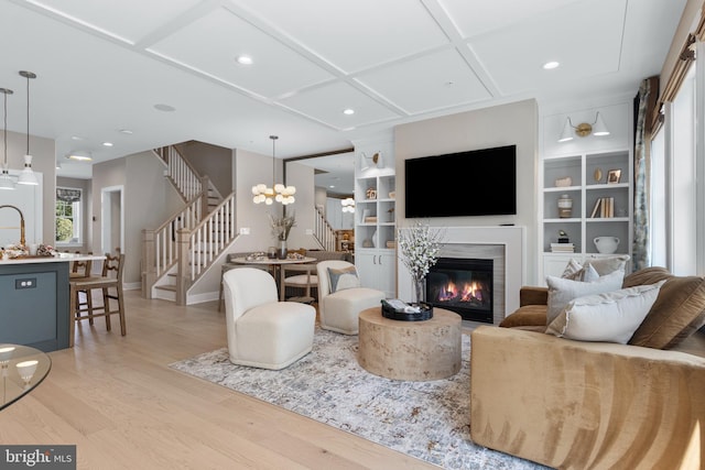 450 Regans Ln Lot 45, Chalfont, PA 18914 - living area featuring stairs, light wood-style floors, a glass covered fireplace, baseboards, and coffered ceiling