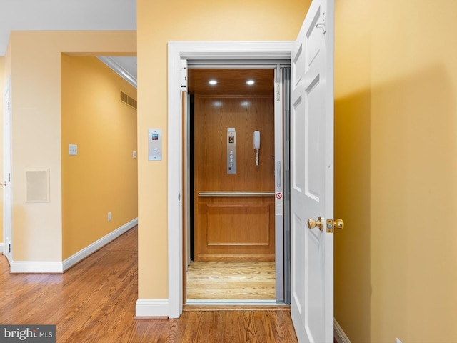 2000 N Bancroft Pkwy, Wilmington, DE 19806 - corridor featuring elevator, wood finished floors, baseboards, and crown molding