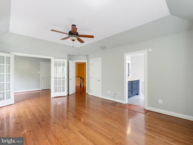 2000 N Bancroft Pkwy, Wilmington, DE 19806 - unfurnished bedroom with light wood-type flooring, baseboards, lofted ceiling, french doors, and ensuite bathroom