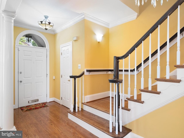 2000 N Bancroft Pkwy, Wilmington, DE 19806 - foyer with wood finished floors, crown molding, stairway, baseboards, and ornate columns