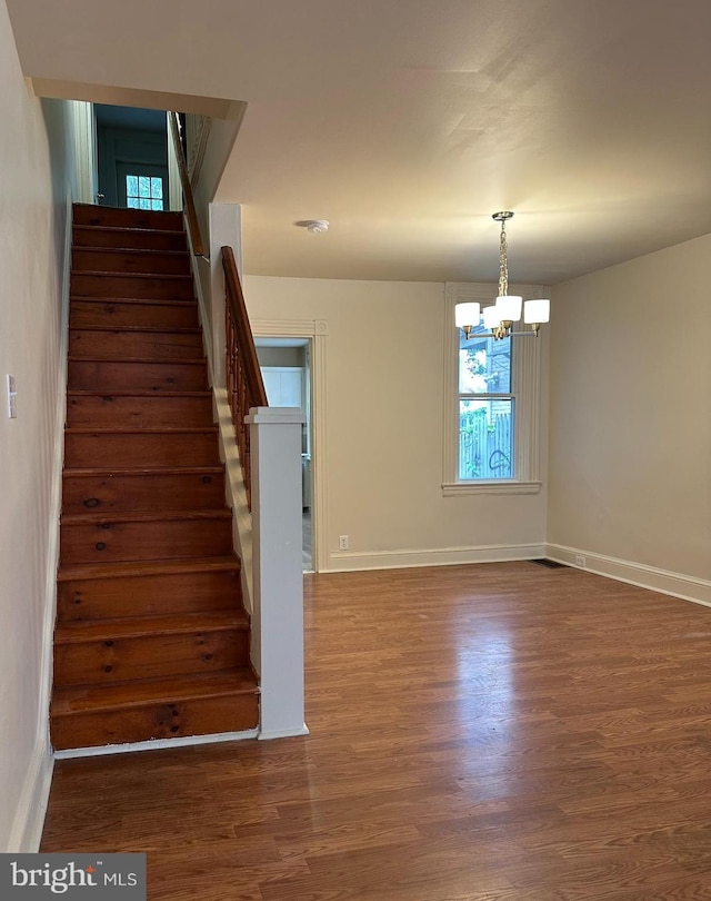 33 New Dorwart St, Lancaster, PA 17603 - stairway featuring wood finished floors, a chandelier, and baseboards