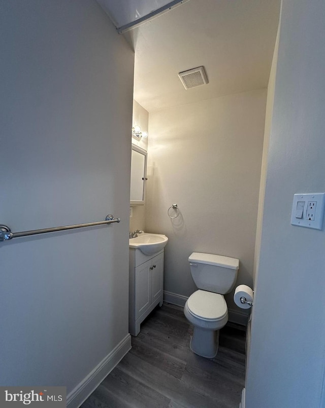 33 New Dorwart St, Lancaster, PA 17603 - bathroom featuring wood finished floors, vanity, toilet, and baseboards