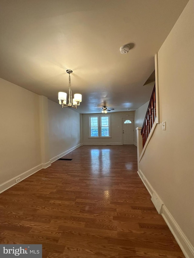 33 New Dorwart St, Lancaster, PA 17603 - spare room with baseboards, dark wood-style flooring, a chandelier, stairs, and ceiling fan