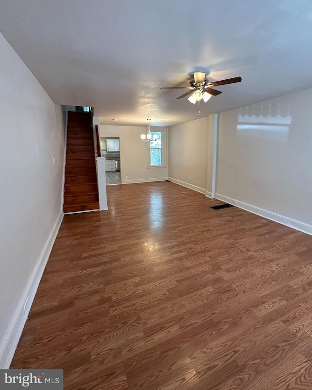 33 New Dorwart St, Lancaster, PA 17603 - unfurnished living room featuring a ceiling fan, baseboards, dark wood-type flooring, and a chandelier