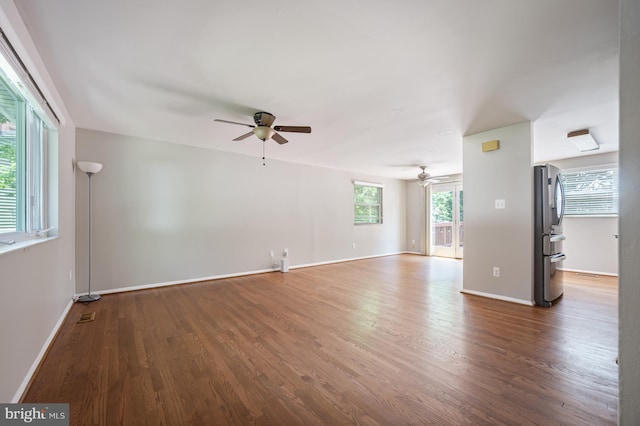 1100 Clarke St, Herndon, VA 20170 - unfurnished living room featuring ceiling fan, wood finished floors, and baseboards