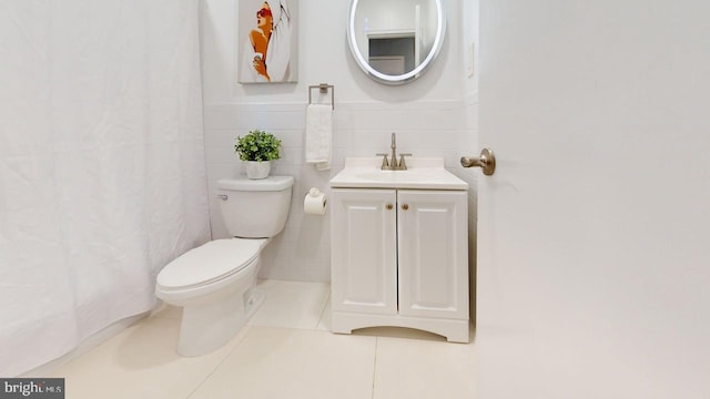 35 Bayberry Rd, Ewing, NJ 08618 - bathroom featuring vanity, tile patterned floors, toilet, a wainscoted wall, and tile walls