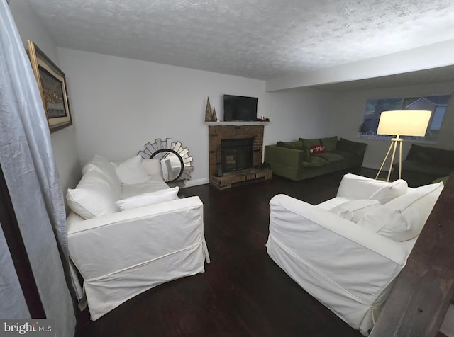 13721 Hobart Dr, Silver Spring, MD 20904 - living area featuring a textured ceiling, wood finished floors, and a brick fireplace