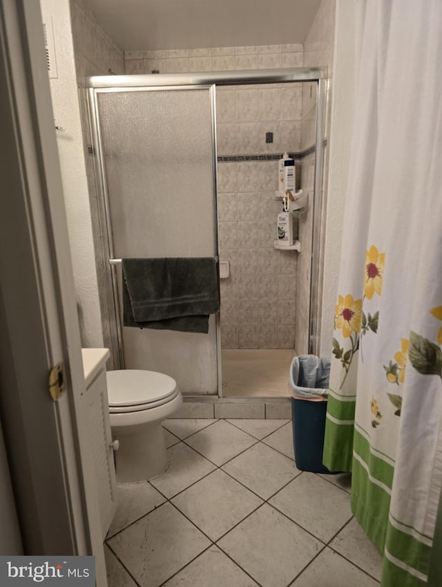 13721 Hobart Dr, Silver Spring, MD 20904 - bathroom featuring a shower stall, toilet, tile patterned flooring, and vanity
