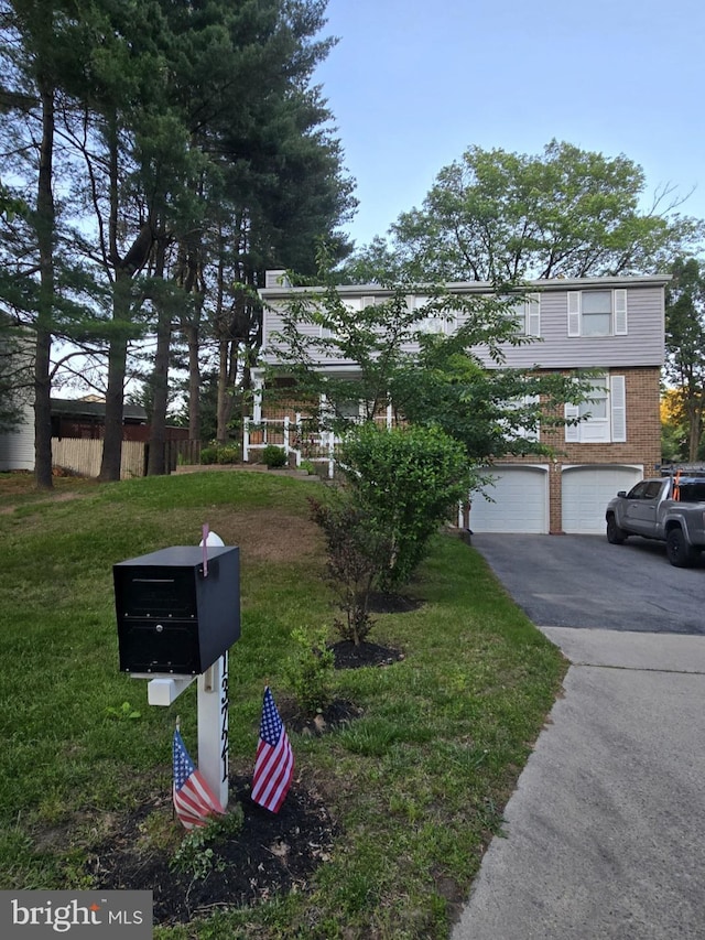 13721 Hobart Dr, Silver Spring, MD 20904 - view of front of house featuring driveway, a garage, brick siding, and a front lawn