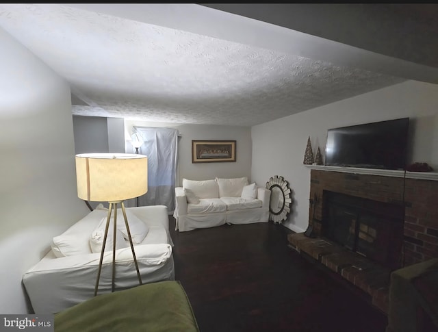 13721 Hobart Dr, Silver Spring, MD 20904 - living room featuring a textured ceiling, a brick fireplace, and wood finished floors