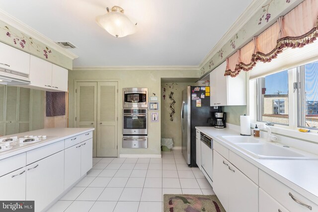 1368 Boardwalk Unit B, Ocean City, NJ 08226 - kitchen with stainless steel appliances, a warming drawer, ornamental molding, a sink, and light countertops