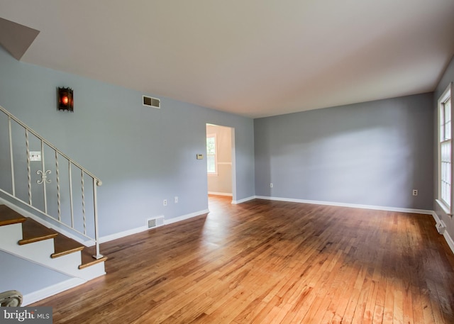 3900 Mark Ave, Harrisburg, PA 17110 - unfurnished living room featuring stairs, wood-type flooring, and baseboards