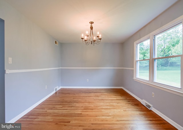 3900 Mark Ave, Harrisburg, PA 17110 - unfurnished room with a chandelier, light wood-style flooring, and baseboards