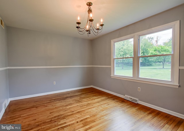 3900 Mark Ave, Harrisburg, PA 17110 - spare room with a chandelier, baseboards, and wood finished floors