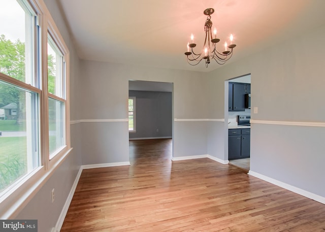 3900 Mark Ave, Harrisburg, PA 17110 - unfurnished room featuring a chandelier, light wood finished floors, and baseboards