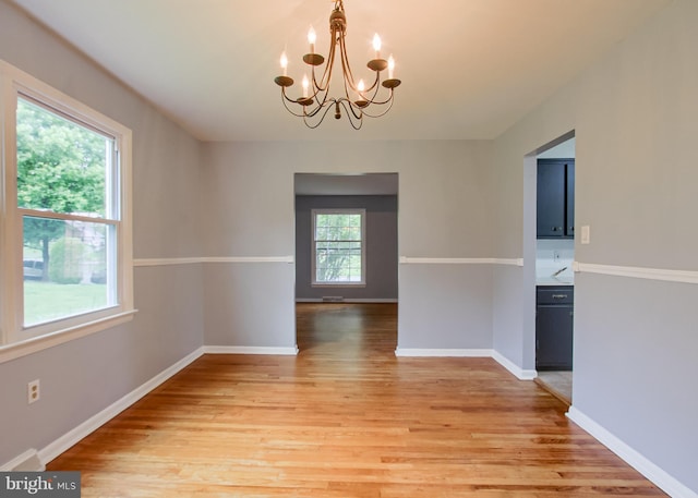 3900 Mark Ave, Harrisburg, PA 17110 - unfurnished dining area with a chandelier, light wood finished floors, and baseboards